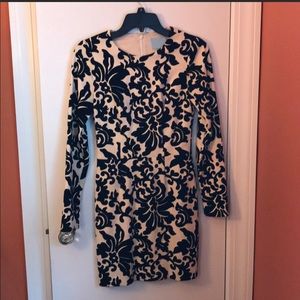 Raised black velvet design in cream background.